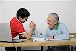 Grandfather and boy arm wrestling fully_released