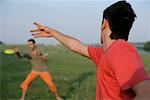 Zwei junge Männer mit einem Frisbee spielen