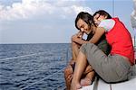 Couple sitting at sailboat border