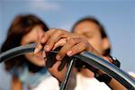 Couple at thesteering wheel of a sailboat