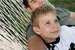 Father and son lying together in a hammock