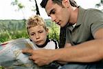 Father and son looking at a world map