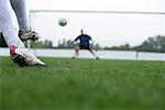 Soccer player kicking a goal