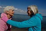 Two mature women standing vis-à- vis at Baltic Sea beach