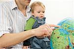 Father explaining a globe to son