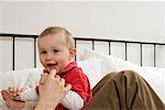 Mother and son sitting on a bed