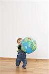 Baby boy holding a globe