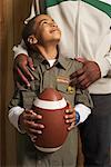 Child Holding a Football