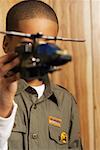 Child Playing with Toy Helicopter