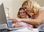 Mother Using Lap Top with Daughter