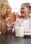 Mother and Daughter Eating Milk and Cookies