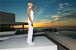 Woman Standing on Patio, Looking at Ocean