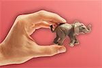 Person's Hands Holding Toy Elephant