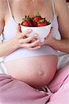 Pregnant Woman Holding Bowl of Strawberries