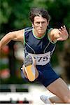 Male Runner Clearing a Hurdle