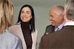 Group of business men and women in a meeting, talking cheerfully