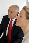 Elderly manager and business woman in a meeting looking serious, while listening