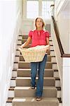 Woman Descending Stairs with Laundry Basket