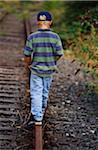 Boy Walking Along Train Tracks