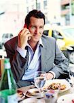 Businessman at Restaurant with Cellular Phone