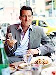 Businessman at Restaurant with Cellular Phone