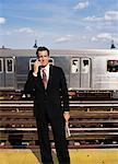 Businessman on Subway Platform, Talking on Cellular Phone