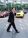 Businessman with Cellular Phone Crossing Street