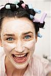 Woman Wearing Face Cream And Curlers