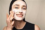 Woman Applying Facial Mud Mask