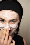 Woman Applying Facial Mud Mask