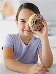 Little Girl Looking Through Doughnut Hole