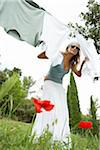 Woman Hanging Laundry on Clothesline