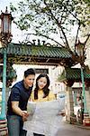 Couple Looking at Map in Street, Chinatown, San Francisco, California, USA