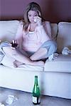 Woman with Red Wine Crying on Sofa