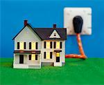 Miniature House Plugged into Electric Socket