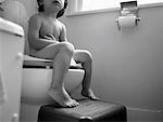 Child Sitting on Toilet