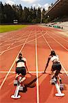 Women Poised on Racetrack