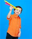 Boy Playing With Paper Airplane