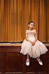 Girl Sitting on Stage