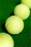 High angle view of four tennis balls in a row