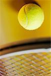 Close-up of a tennis ball and a tennis racket