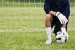 Close-up of a goalie touching a soccer ball