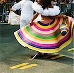 Rear view of a man and a woman dancing at a gay parade