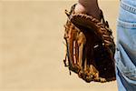 Mid section view of a baseball player wearing a baseball glove