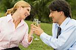 Mid adult man and a young woman holding champagne flutes