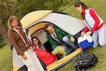 Mature man and a mid adult woman camping with their two daughters