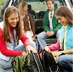 Side profile of two girls holding bags and smiling