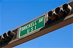 Low angle view of traffic lights with an information sign, Miami, Florida, USA