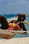 Desiree Lynes wearing a sarong lies on a hammock, Crystal Palace Hotel, Nassau, Bermuda