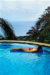 A woman is relaxing in a swimming pool at Destiny Villa, Jamaica